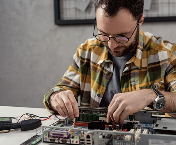 Solavita technician focusing on circuit board integration for energy storage systems