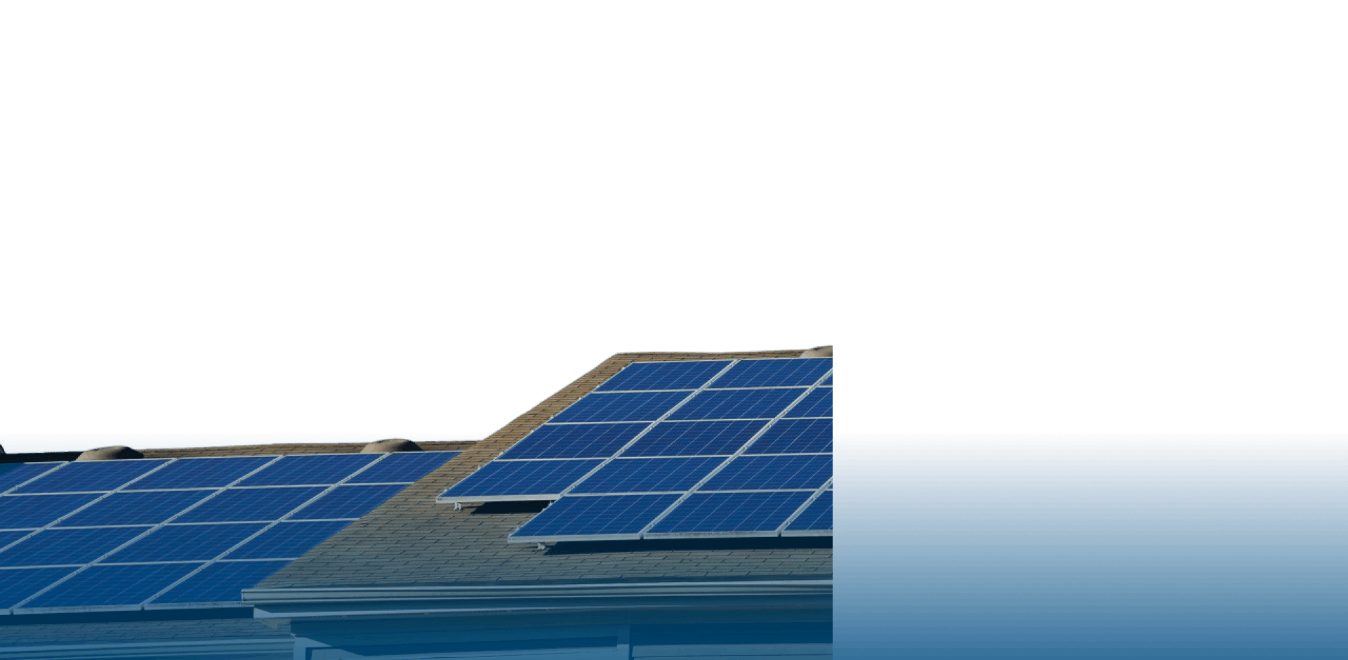 Residential rooftop solar panels installed on a sloped shingle roof under clear blue sky