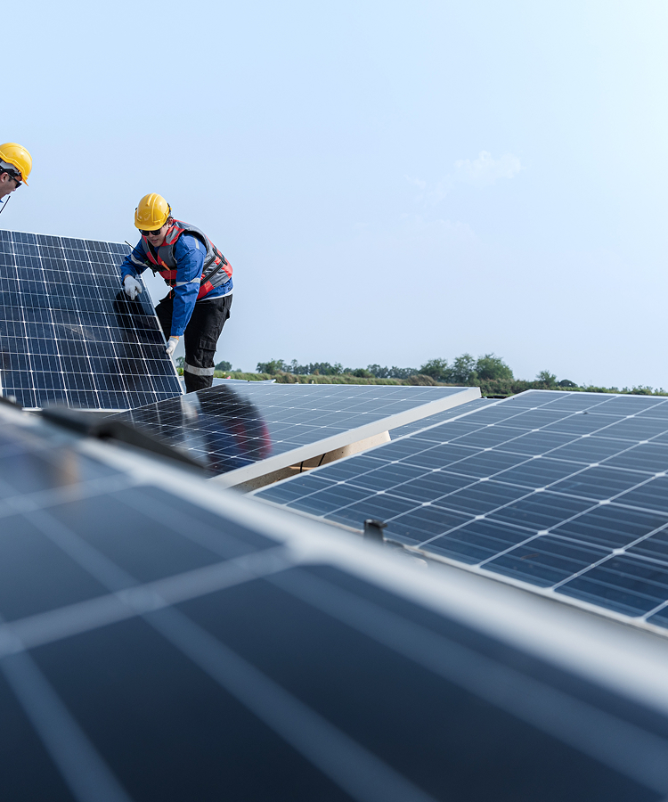 Solavita engineers installing photovoltaic panels on rooftop solar EPC project site
